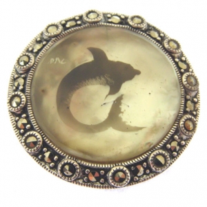 candle smoked silver dolphin brooch on mother of pearl