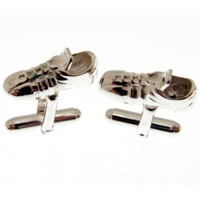 silver cufflinks with a football or rugby boot theme